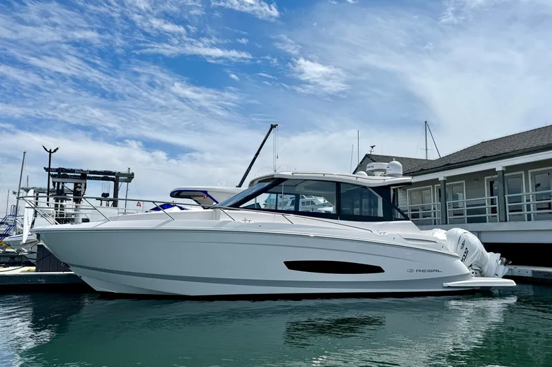 36 Xo Yacht Photos Pics 2026 Regal 36 XO yacht docked at marina under blue sky.
