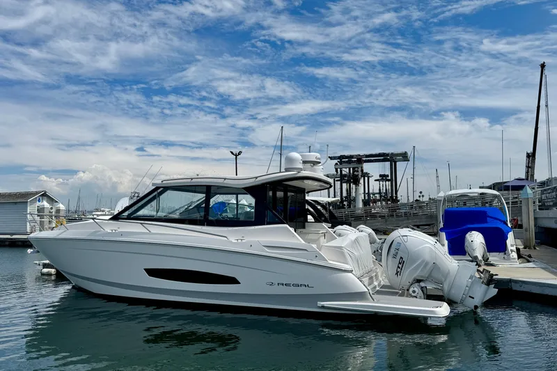 36 Xo Yacht Photos Pics 2026 Regal 36 XO boat docked at marina under blue sky.
