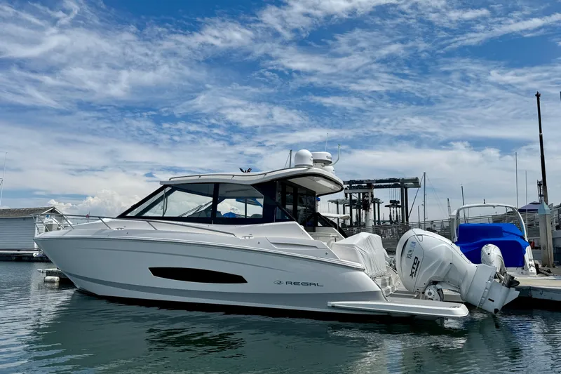 36 Xo Yacht Photos Pics 2026 Regal 36 XO boat docked at marina under blue sky.