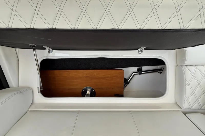 36 Xo Yacht Photos Pics 2026 Regal 36 XO boat interior storage compartment with white cushioned seating.