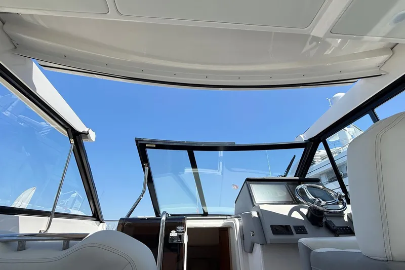 36 Xo Yacht Photos Pics Interior view of 2026 Regal 36 XO yacht cockpit with steering wheel and clear sky.