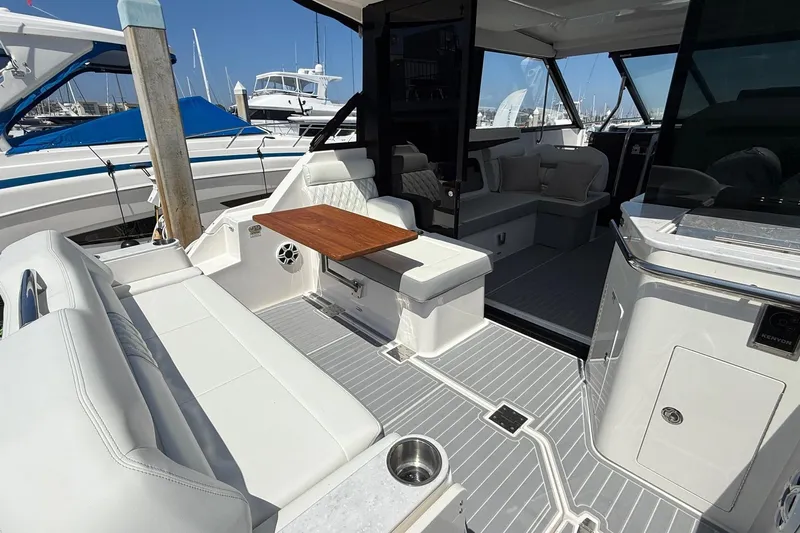 36 Xo Yacht Photos Pics 2026 Regal 36 XO yacht interior with white seating, wooden table, and modern design.