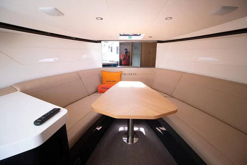  Yacht Photos Pics Interior of 2021 Fairline F Line 33 yacht with beige seating and wooden table.
