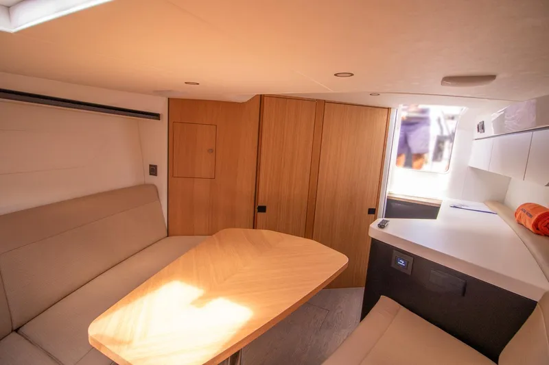  Yacht Photos Pics Interior of 2021 Fairline F Line 33 yacht with modern seating and wooden table.