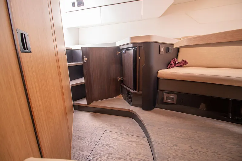  Yacht Photos Pics Interior cabin of 2021 Fairline F Line 33 yacht with wooden cabinetry and seating.