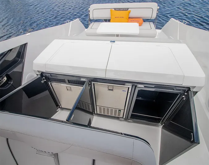  Yacht Photos Pics 2021 Fairline F Line 33 yacht with open storage compartments and seating area.