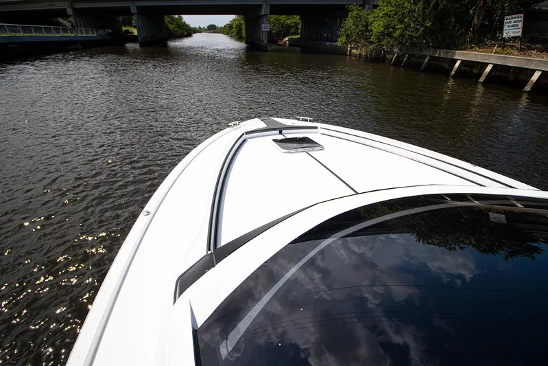  Yacht Photos Pics Fairline F Line 33 2021 yacht cruising on a river under a bridge.