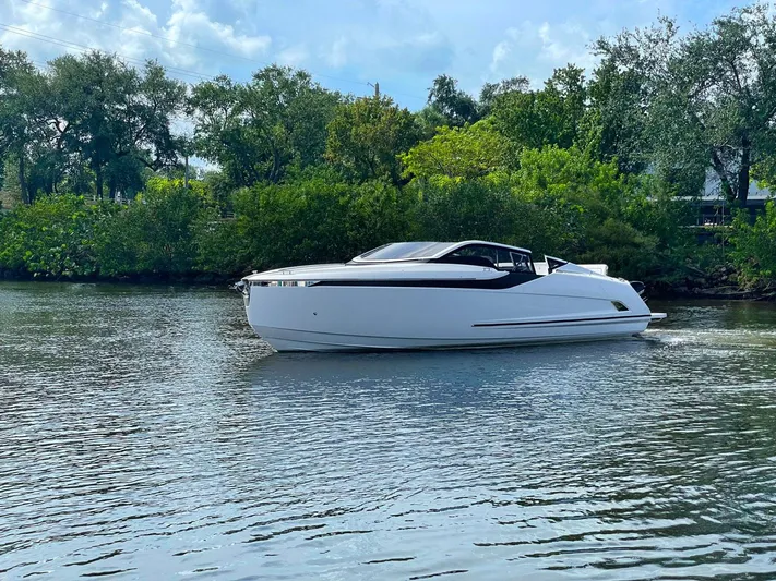  Yacht Photos Pics 2021 Fairline F Line 33 luxury yacht cruising on a serene river.