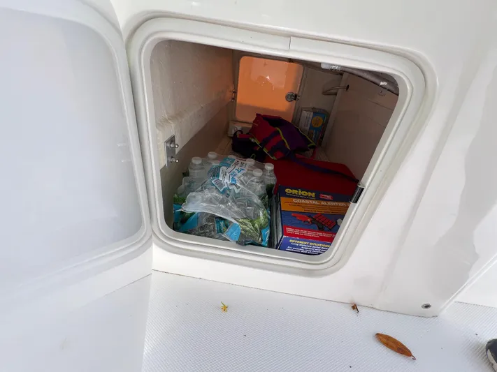  Yacht Photos Pics Storage compartment of 2023 SeaVee 340Z boat with water bottles and safety gear.