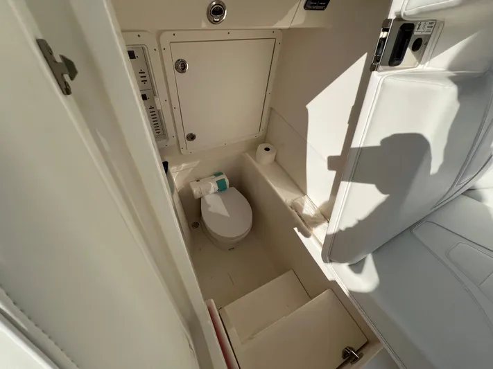  Yacht Photos Pics 2023 SeaVee 340Z boat interior bathroom with toilet and storage compartments.