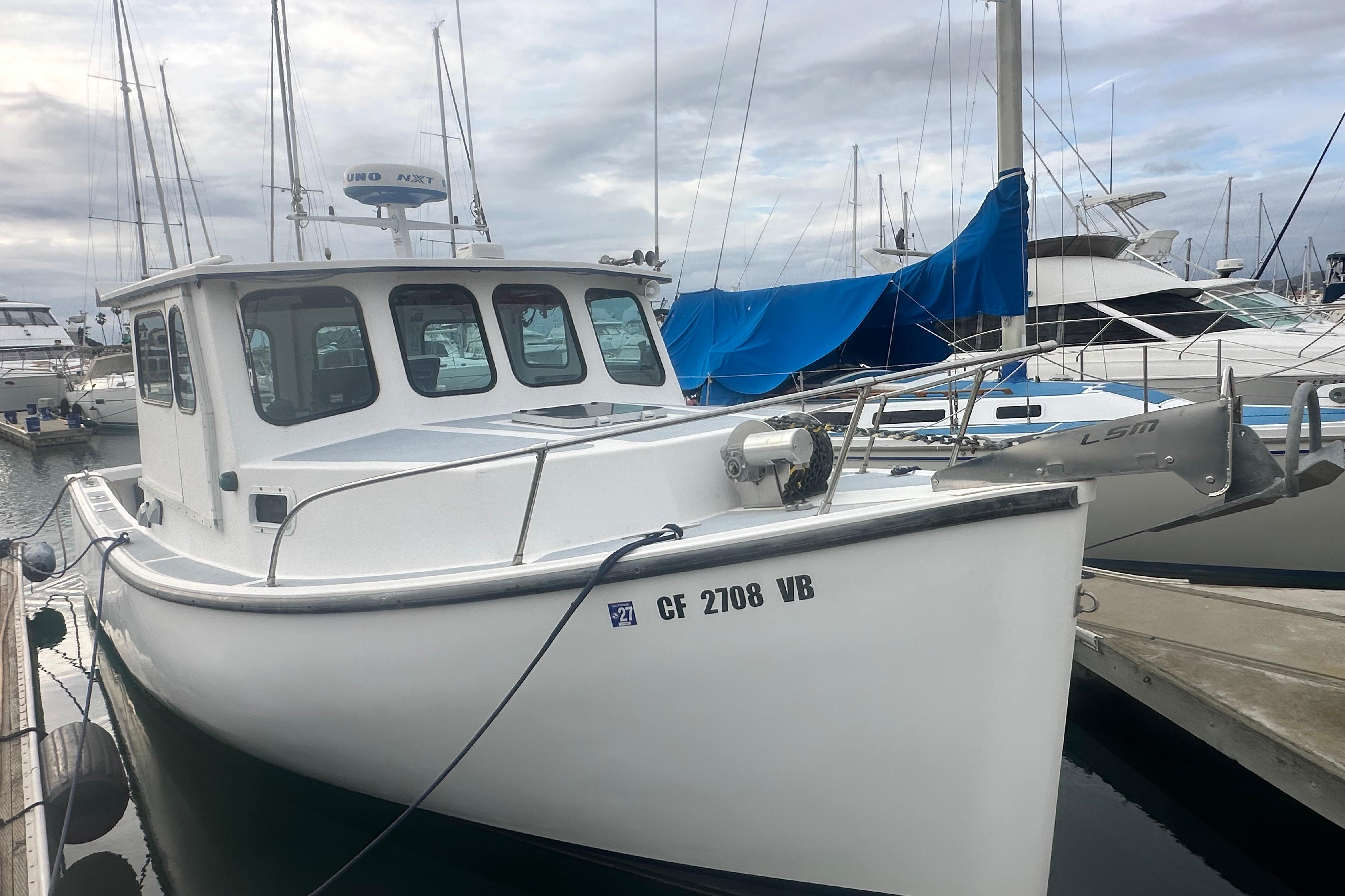 1999 Samson East Coast Lobster boat docked at marina under cloudy sky.