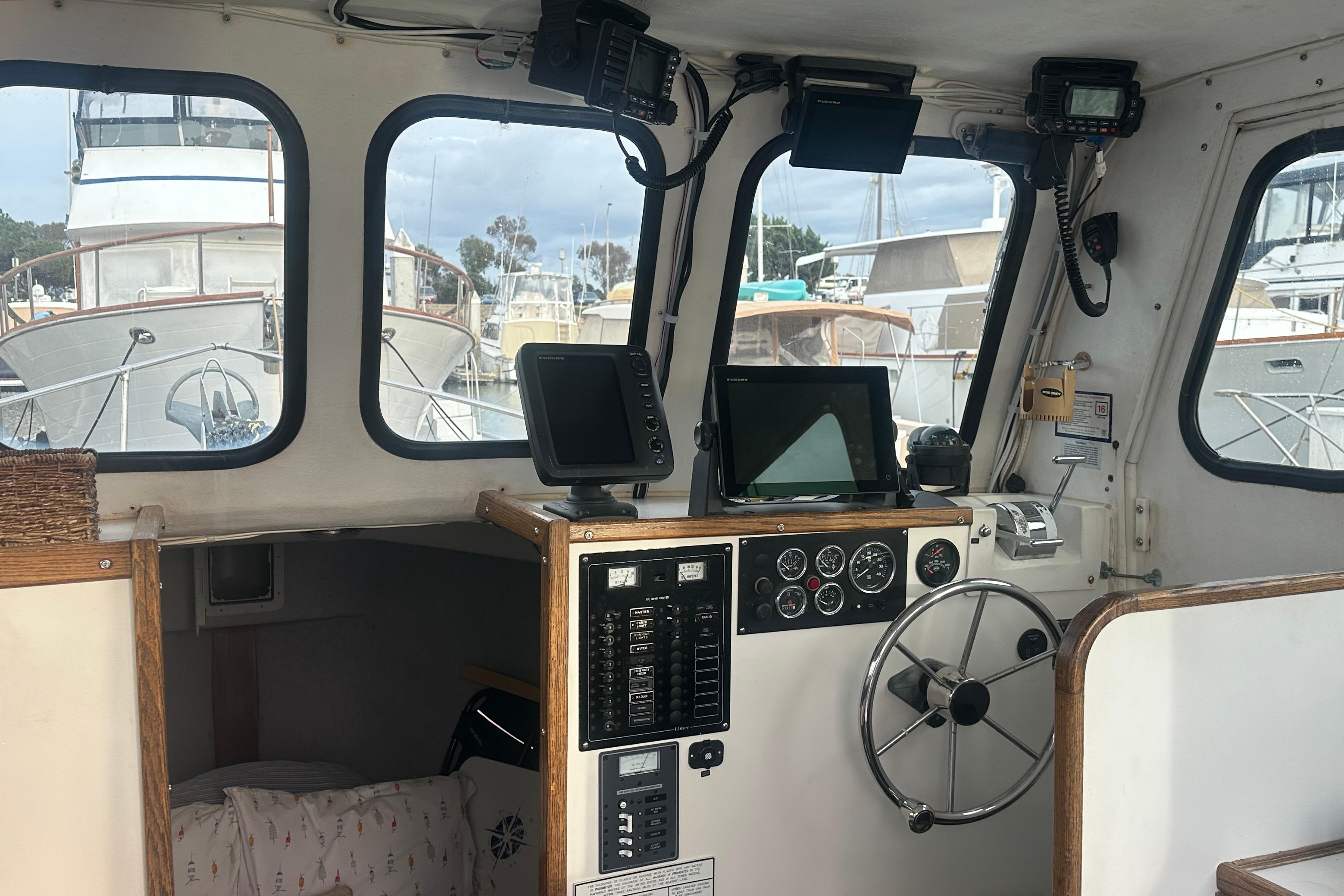 Interior of a 1999 Samson East Coast Lobster boat with navigation equipment and steering wheel.