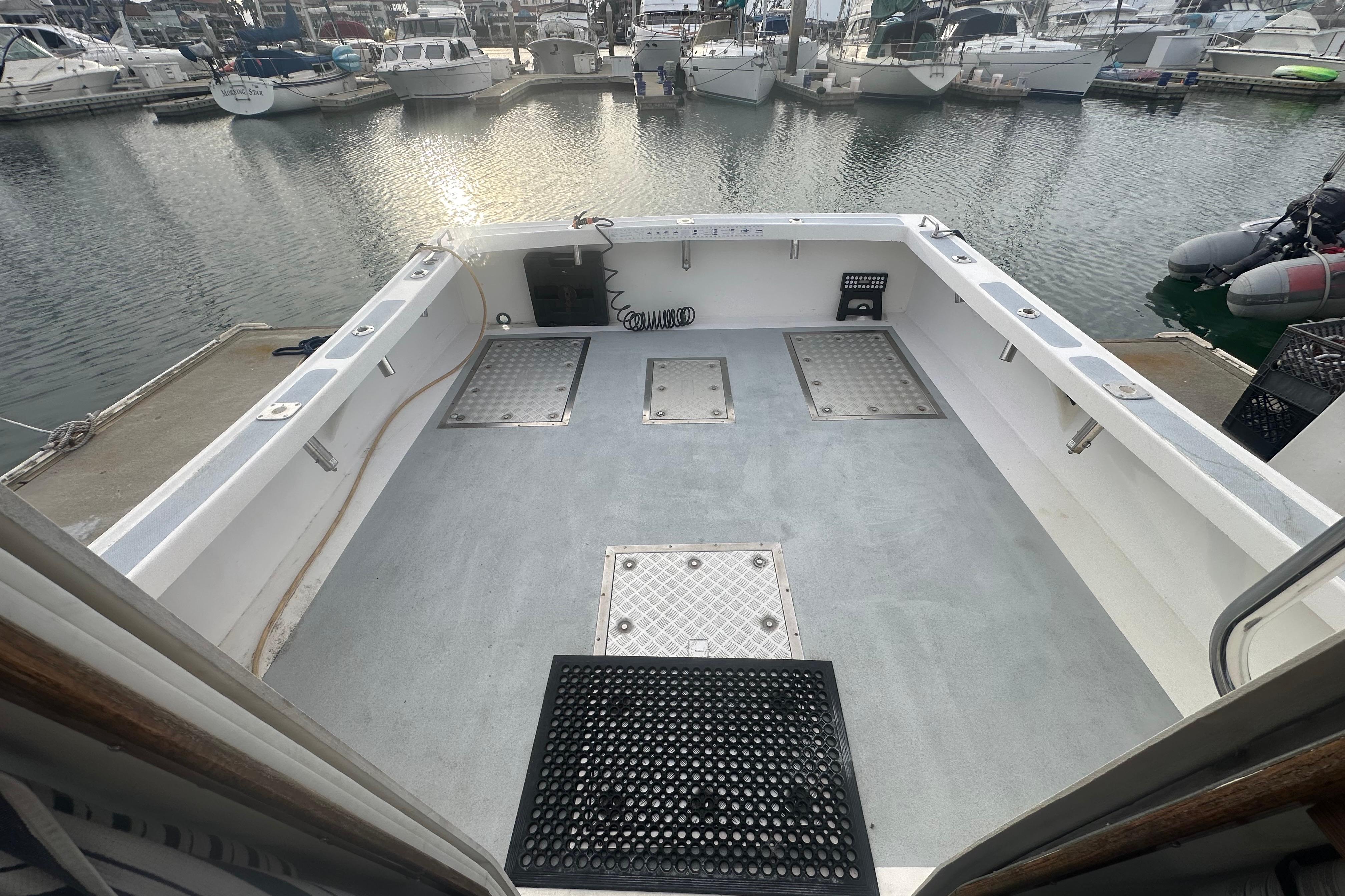 Open deck of a 1999 Samson East Coast Lobster boat in a marina.