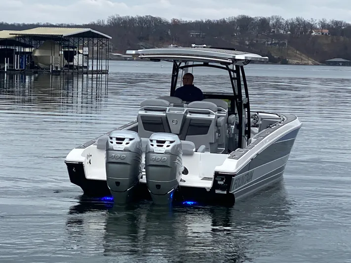  Yacht Photos Pics 2023 Fountain 34 SC boat with dual engines on a calm lake.