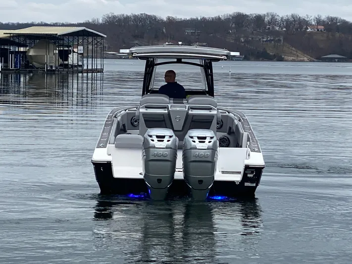  Yacht Photos Pics 2023 Fountain 34 SC boat with dual 400 engines on a calm lake.