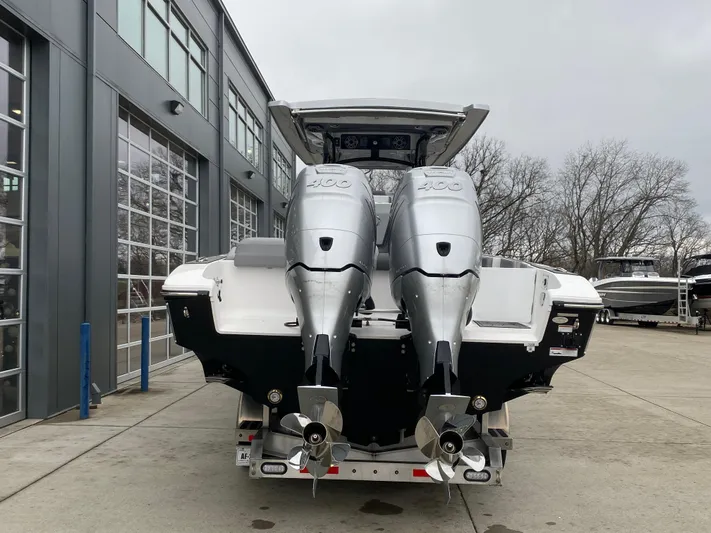  Yacht Photos Pics 2023 Fountain 34 SC boat with dual outboard motors in a marina setting.