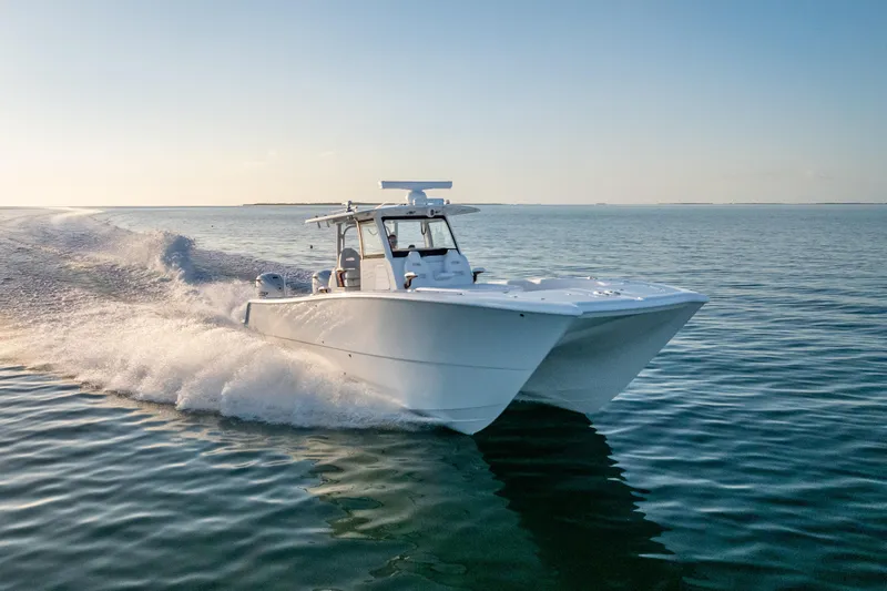  Yacht Photos Pics 2026 Freeman 35 boat cruising on calm ocean waters at sunset.