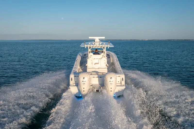  Yacht Photos Pics 2026 Freeman 35 boat cruising on open water, rear view with twin engines.