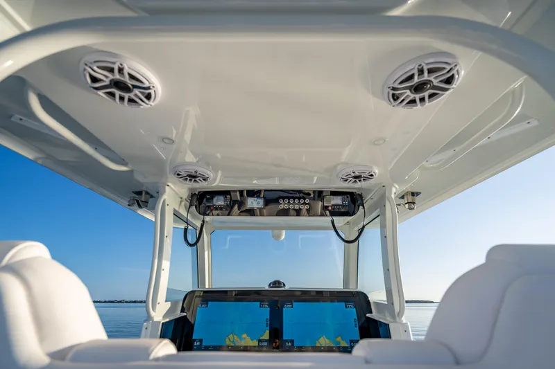  Yacht Photos Pics Interior view of 2026 Freeman 35 boat cockpit with navigation screens and speakers.