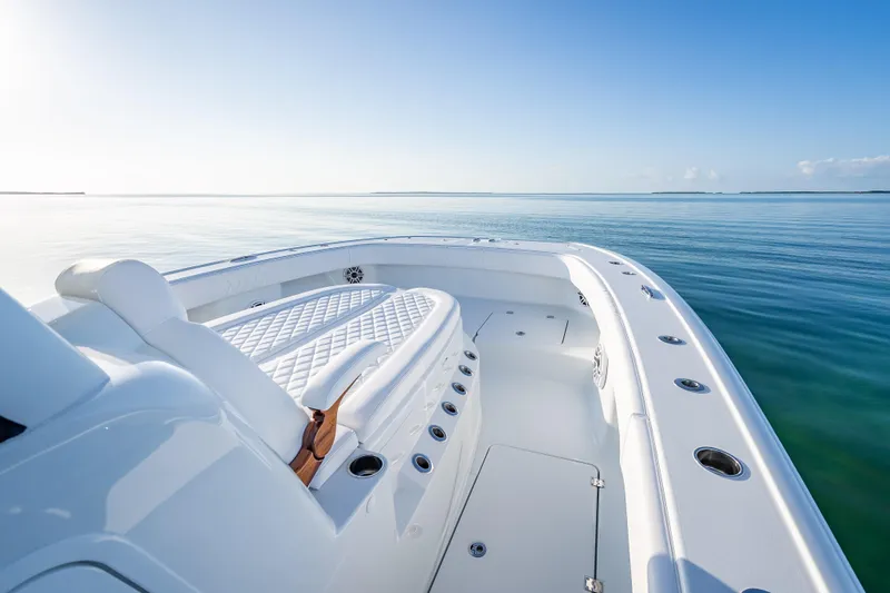  Yacht Photos Pics 2026 Freeman 35 boat on calm ocean, featuring sleek white deck and seating.