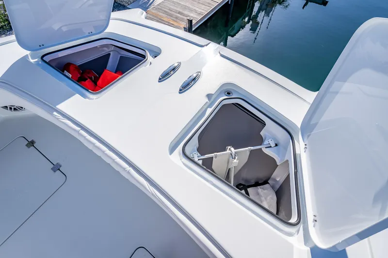  Yacht Photos Pics Open storage compartments on a 2026 Freeman 35 boat deck, featuring life jackets and equipment.