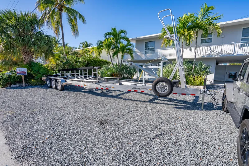  Yacht Photos Pics Trailer for Freeman 35 boat, 2026 model, parked on gravel with tropical plants.