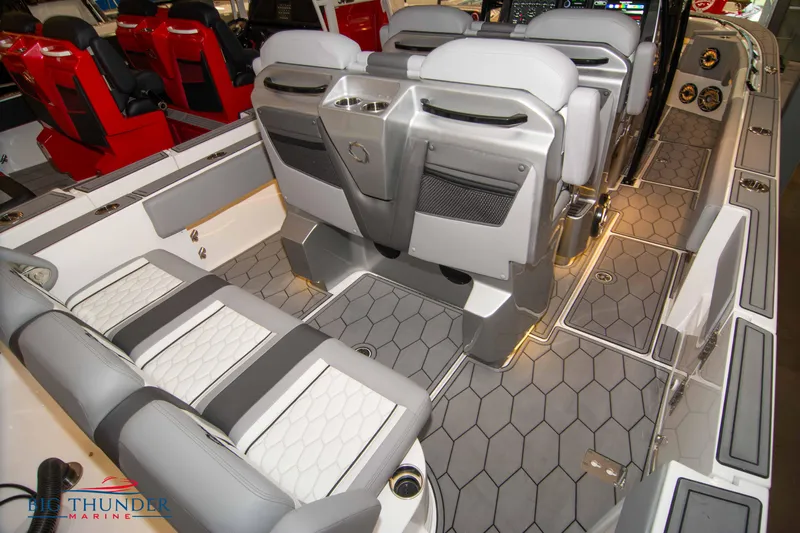  Yacht Photos Pics 2023 Fountain 34 SC boat interior with gray and white seating and hexagonal flooring.