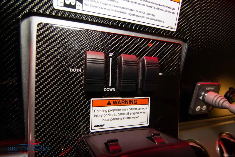  Yacht Photos Pics Control panel of 2023 Fountain 34 SC boat with warning labels and switches.