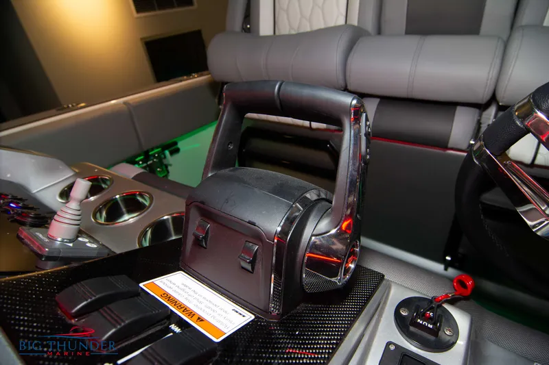  Yacht Photos Pics 2023 Fountain 34 SC boat interior with throttle controls and seating.