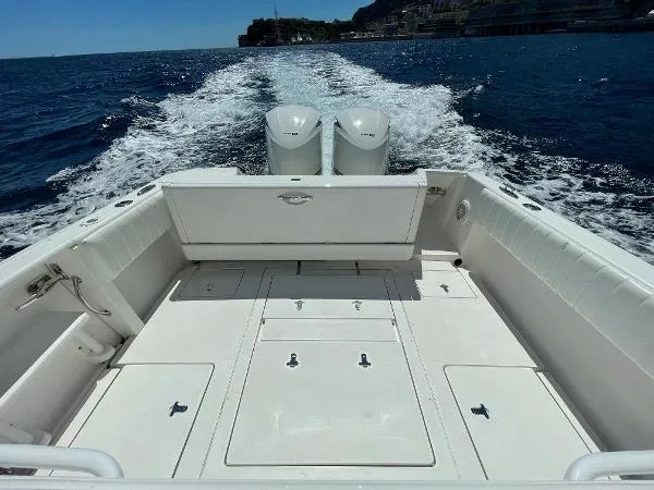  Yacht Photos Pics 2013 Intrepid 327 OPEN boat cruising on open water, showcasing spacious deck and twin engines.