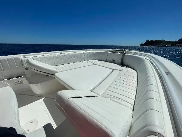  Yacht Photos Pics 2013 Intrepid 327 OPEN boat with white seating, ocean view, and clear blue sky.
