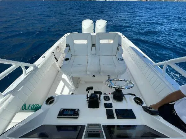  Yacht Photos Pics 2013 Intrepid 327 OPEN boat interior with dual seats and control panel on open water.