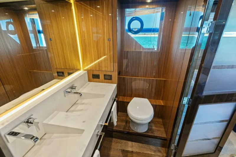  Yacht Photos Pics Luxurious bathroom in 2018 Cruisers Yachts 60 Fly, featuring modern fixtures and wood accents.