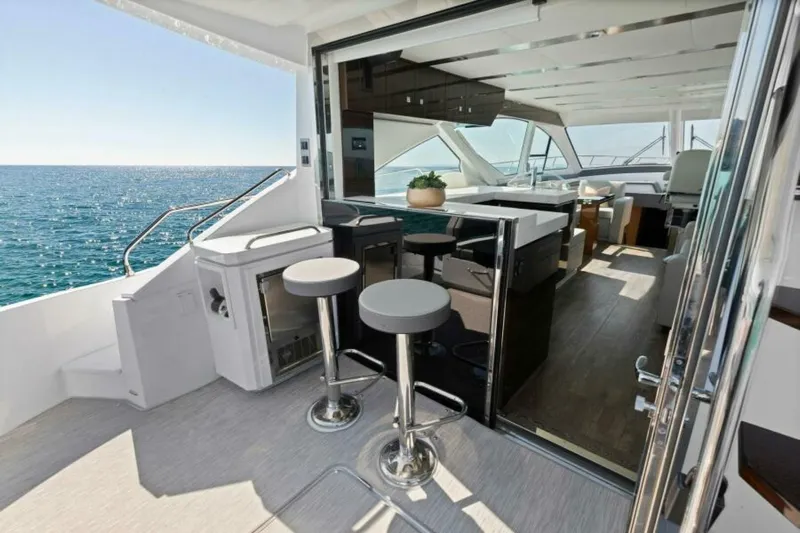  Yacht Photos Pics Luxurious 2018 Cruisers Yachts 60 Fly interior with ocean view and modern seating area.