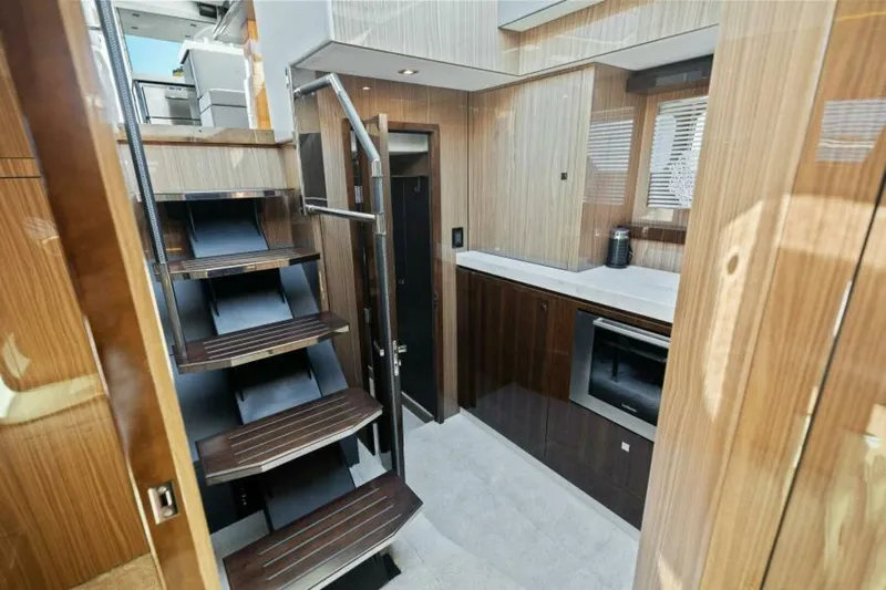  Yacht Photos Pics Luxurious interior of 2018 Cruisers Yachts 60 Fly with modern staircase and cabinetry.