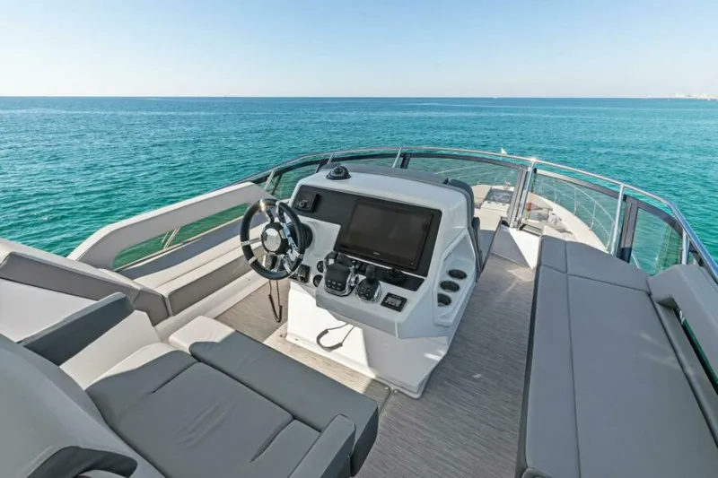  Yacht Photos Pics 2018 Cruisers Yachts 60 Flybridge helm with ocean view, featuring modern controls and seating.