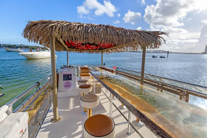 Tiki International Yacht Photos Pics Tiki-themed Beachcat 26 Tiki COI boat with bar stools and ocean view, 2023 model.