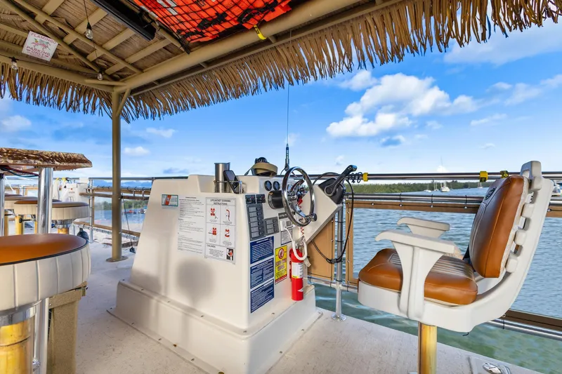 Tiki International Yacht Photos Pics Helm of 2023 Beachcat 26 Tiki COI boat with tropical decor and water view.