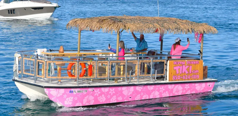 Tiki International Yacht Photos Pics Tiki-themed Beachcat 26 Tiki COI boat cruising on water, 2023 model, with passengers enjoying the ride.