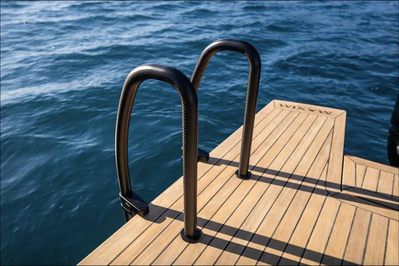 Max44r Yacht Photos Pics Luxury yacht swim platform with ladder, Maxim Yachts MAX44R 2025, on serene blue water.