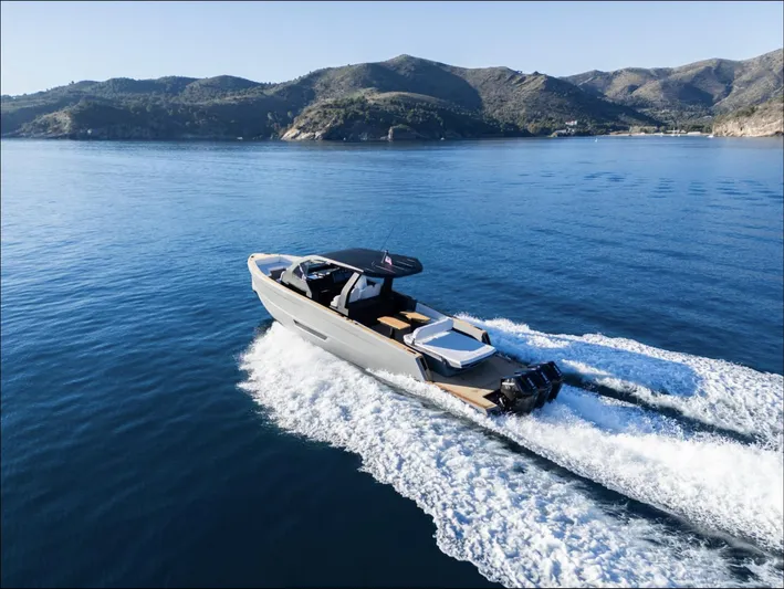 Max44r Yacht Photos Pics 2025 Maxim Yachts MAX44R cruising on serene blue waters near scenic mountains.