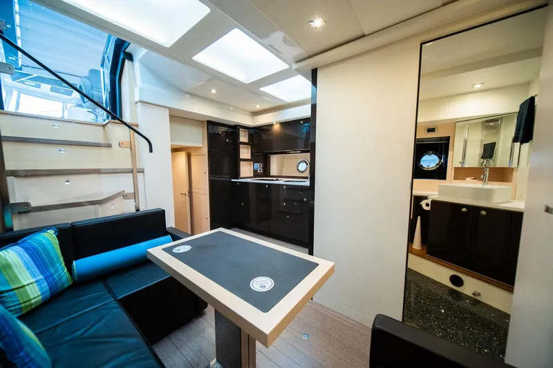 Dominus Yacht Photos Pics Luxurious interior of a 2012 Cranchi 56 yacht with modern kitchen and seating area.