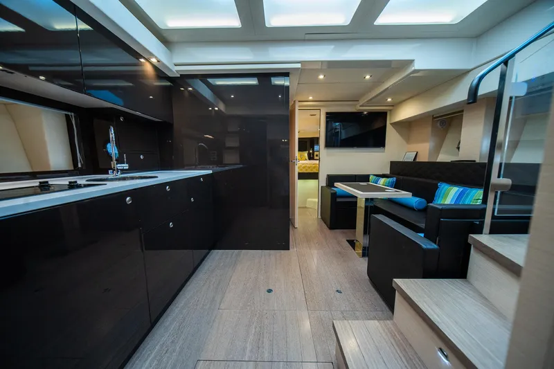 Dominus Yacht Photos Pics Luxurious interior of 2012 Cranchi 56 yacht with modern kitchen and seating area.