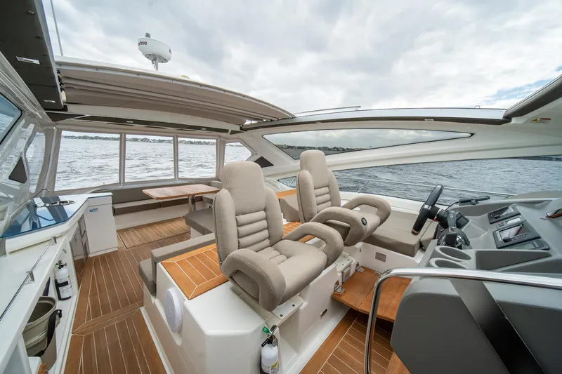 Dominus Yacht Photos Pics Luxurious interior of 2012 Cranchi 56 yacht with plush seating and modern helm.