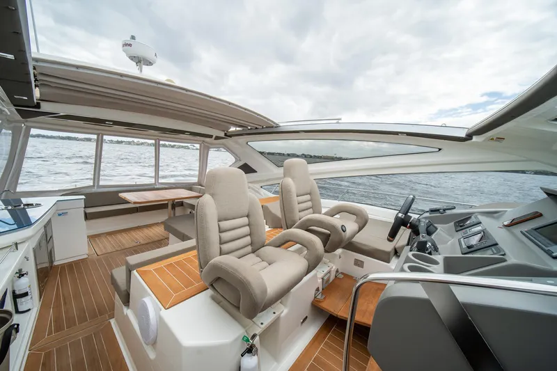 Dominus Yacht Photos Pics Luxurious interior of 2012 Cranchi 56 yacht with plush seating and modern controls.