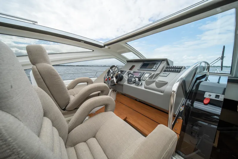 Dominus Yacht Photos Pics Cockpit of 2012 Cranchi 56 yacht with modern controls and plush seating.