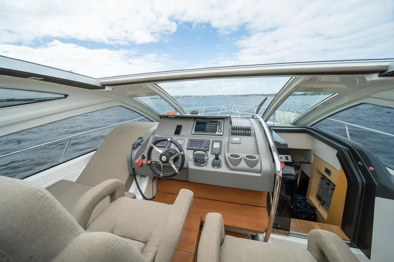 Dominus Yacht Photos Pics Interior helm of 2012 Cranchi 56 yacht with modern navigation equipment and panoramic windows.
