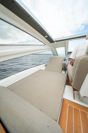 Dominus Yacht Photos Pics Interior view of 2012 Cranchi 56 yacht with cushioned seating.