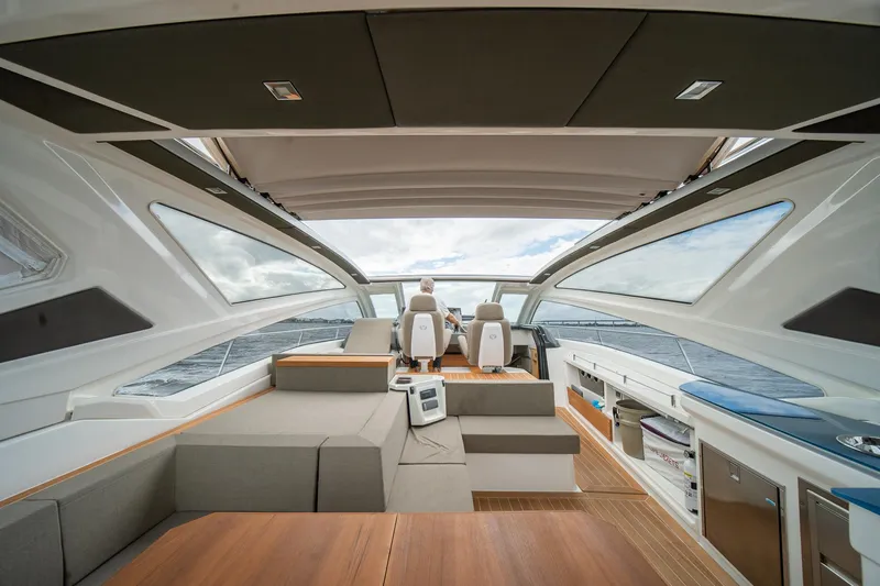 Dominus Yacht Photos Pics Interior of 2012 Cranchi 56 yacht with modern seating and panoramic windows.