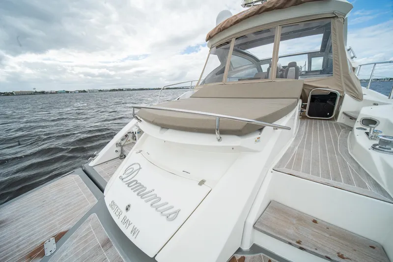 Dominus Yacht Photos Pics 2012 Cranchi 56 yacht on water with spacious deck and seating area.